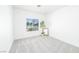 Bright bedroom with neutral carpet, a large window, and a view of the neighborhood at 10301 Coal Creek Pl, Las Vegas, NV 89134