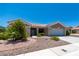 Inviting home exterior featuring desert landscaping, a two-car garage, and a tiled roof at 10301 Coal Creek Pl, Las Vegas, NV 89134