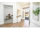 Foyer with wood floors, a decorative table, and an office and exterior view at 10301 Coal Creek Pl, Las Vegas, NV 89134