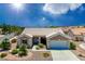 Charming single-story home featuring a well-manicured front yard with vibrant plants at 10301 Coal Creek Pl, Las Vegas, NV 89134