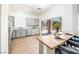 Well-lit kitchen with stainless steel appliances, gray cabinetry, a breakfast bar, and sliding glass doors to the outside at 10301 Coal Creek Pl, Las Vegas, NV 89134