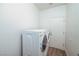Practical laundry area featuring a side-by-side washer and dryer and easy access to an exterior door at 10301 Coal Creek Pl, Las Vegas, NV 89134