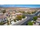 This aerial view shows two-story residential houses with solar panels near a desert landscape at 10519 Mann St, Las Vegas, NV 89141