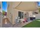 Charming backyard with patio, artificial turf, privacy fence, and sun-blocking canvas at 10519 Mann St, Las Vegas, NV 89141