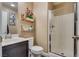 Cozy bathroom with a walk-in shower and decorative shelving for storage at 10519 Mann St, Las Vegas, NV 89141