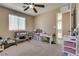 Neutral bedroom with window, ceiling fan, and a pack-n-play at 10519 Mann St, Las Vegas, NV 89141