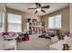 Cozy bedroom features neutral colors, a ceiling fan, and plenty of natural light at 10519 Mann St, Las Vegas, NV 89141