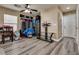 Bonus room with stylish gray vinyl plank flooring, neutral paint, and ceiling fan at 10519 Mann St, Las Vegas, NV 89141