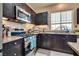 Well-lit kitchen featuring a stainless steel range and granite countertops at 10519 Mann St, Las Vegas, NV 89141