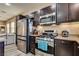Modern kitchen with stainless steel appliances and dark cabinetry at 10519 Mann St, Las Vegas, NV 89141