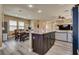 Open-concept kitchen features a large island, stainless appliances, and adjacent dining area at 10519 Mann St, Las Vegas, NV 89141