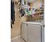 Functional laundry room is equipped with appliances and shelving at 10519 Mann St, Las Vegas, NV 89141