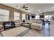 Spacious living room featuring a large sectional sofa and wood-look flooring at 10519 Mann St, Las Vegas, NV 89141