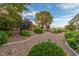 Backyard showcasing desert landscaping with winding walkways and vibrant greenery at 10832 Heritage Hills Dr, Las Vegas, NV 89134