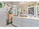 Bathroom with white cabinets, large mirror, and glass enclosed shower at 10832 Heritage Hills Dr, Las Vegas, NV 89134