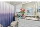 Bathroom featuring single vanity with marble countertop, a toilet, and shower with patterned curtain at 10832 Heritage Hills Dr, Las Vegas, NV 89134