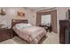 Comfortable bedroom with a large bed, soft lighting, a window with coverings, and ample closet space at 10832 Heritage Hills Dr, Las Vegas, NV 89134