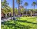 Beautiful common area with lush landscaping, palm trees, and a decorative fountain at 10832 Heritage Hills Dr, Las Vegas, NV 89134