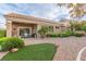 Single-story home featuring a covered patio and low-maintenance gravel landscaping with green shrubbery at 10832 Heritage Hills Dr, Las Vegas, NV 89134