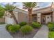 Close up of charming home with decorative front door and well maintained desert landscaping at 10832 Heritage Hills Dr, Las Vegas, NV 89134