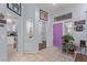 Bright foyer featuring tile flooring, with a unique purple door, and stylish decor elements at 10832 Heritage Hills Dr, Las Vegas, NV 89134