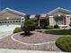 Charming single-story home featuring a well-maintained front yard with desert landscaping, green turf, and mature palm trees at 10832 Heritage Hills Dr, Las Vegas, NV 89134
