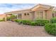 Charming single story home with desert landscaping, mature shrubs, and a covered patio area at 10832 Heritage Hills Dr, Las Vegas, NV 89134
