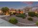 Charming single-story home featuring desert landscaping with mature trees and a well-manicured lawn at 10832 Heritage Hills Dr, Las Vegas, NV 89134