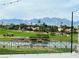 Expansive golf course view with water feature, mature trees, and mountain backdrop from elevated vantage point at 10832 Heritage Hills Dr, Las Vegas, NV 89134