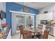Eat-in kitchen features a dining table and updated appliances, bathed in natural light from sliding glass doors at 10832 Heritage Hills Dr, Las Vegas, NV 89134