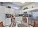 Bright kitchen features stainless steel appliances, white cabinetry, tiled backsplash, and a cozy eat-in area at 10832 Heritage Hills Dr, Las Vegas, NV 89134