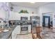 Bright kitchen features stainless appliances, granite counters and white cabinetry at 10832 Heritage Hills Dr, Las Vegas, NV 89134