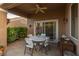 Covered patio with a ceiling fan, outdoor seating, and a view of the landscaped backyard at 10832 Heritage Hills Dr, Las Vegas, NV 89134