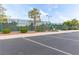Exterior view of a tennis court with parking, highlighting community recreational facilities at 10832 Heritage Hills Dr, Las Vegas, NV 89134