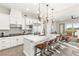 Modern kitchen with a large island, stainless steel appliances, sleek lighting, and an adjacent living space at 11280 Granite Ridge Dr # 1012, Las Vegas, NV 89135