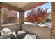 Outdoor patio featuring an arrangement of stylish wicker seating surrounded by brick columns and fall colors at 11280 Granite Ridge Dr # 1012, Las Vegas, NV 89135