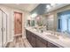 Well-lit bathroom with double sinks, quartz countertops, and a walk-in shower at 1213 Dre Harbor Pl # Lot 83, North Las Vegas, NV 89084