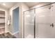 Sleek bathroom with a glass shower, tile surround, and adjacent walk-in closet at 1213 Dre Harbor Pl # Lot 83, North Las Vegas, NV 89084