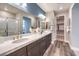 Modern bathroom featuring double sinks, stylish mirrors, and wood-look tile floors at 1213 Dre Harbor Pl # Lot 83, North Las Vegas, NV 89084