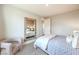Neutral bedroom with a full length mirror, neutral chair, and a glimpse into an ensuite bathroom at 1213 Dre Harbor Pl # Lot 83, North Las Vegas, NV 89084