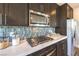 Close-up of a modern kitchen with stainless steel appliances and decorative backsplash at 1213 Dre Harbor Pl # Lot 83, North Las Vegas, NV 89084