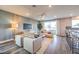 Cozy living room with stylish furniture, entertainment center, and sliding glass doors to the outdoors at 1213 Dre Harbor Pl # Lot 83, North Las Vegas, NV 89084