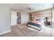 Comfortable main bedroom featuring a stylish headboard, decorative wall, and bright natural light at 1213 Dre Harbor Pl # Lot 83, North Las Vegas, NV 89084