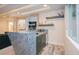 Finished basement bar with a stone countertop, custom cabinetry, and stylish wood-look flooring at 1228 Stellar Rim Ct, Henderson, NV 89012