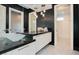 Modern bathroom with dual sinks, quartz counters, pendant lights, and walk-in shower at 1228 Stellar Rim Ct, Henderson, NV 89012