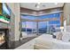 Serene main bedroom with fireplace, television, views of the city, and sliding glass doors to an outdoor area at 1228 Stellar Rim Ct, Henderson, NV 89012