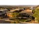 Beautiful contemporary home with desert landscaping and a paved driveway nestled among hillside homes at 1228 Stellar Rim Ct, Henderson, NV 89012