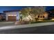 Charming single-Gathering home featuring a spacious driveway, a two-car garage and manicured front yard at 1228 Stellar Rim Ct, Henderson, NV 89012