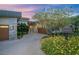 Stunning single story exterior with a circular driveway, lush desert landscaping and natural stone accents at 1228 Stellar Rim Ct, Henderson, NV 89012