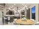 Gourmet kitchen boasts a center island with cooktop, breakfast bar, stainless appliances, and dining area at 1228 Stellar Rim Ct, Henderson, NV 89012